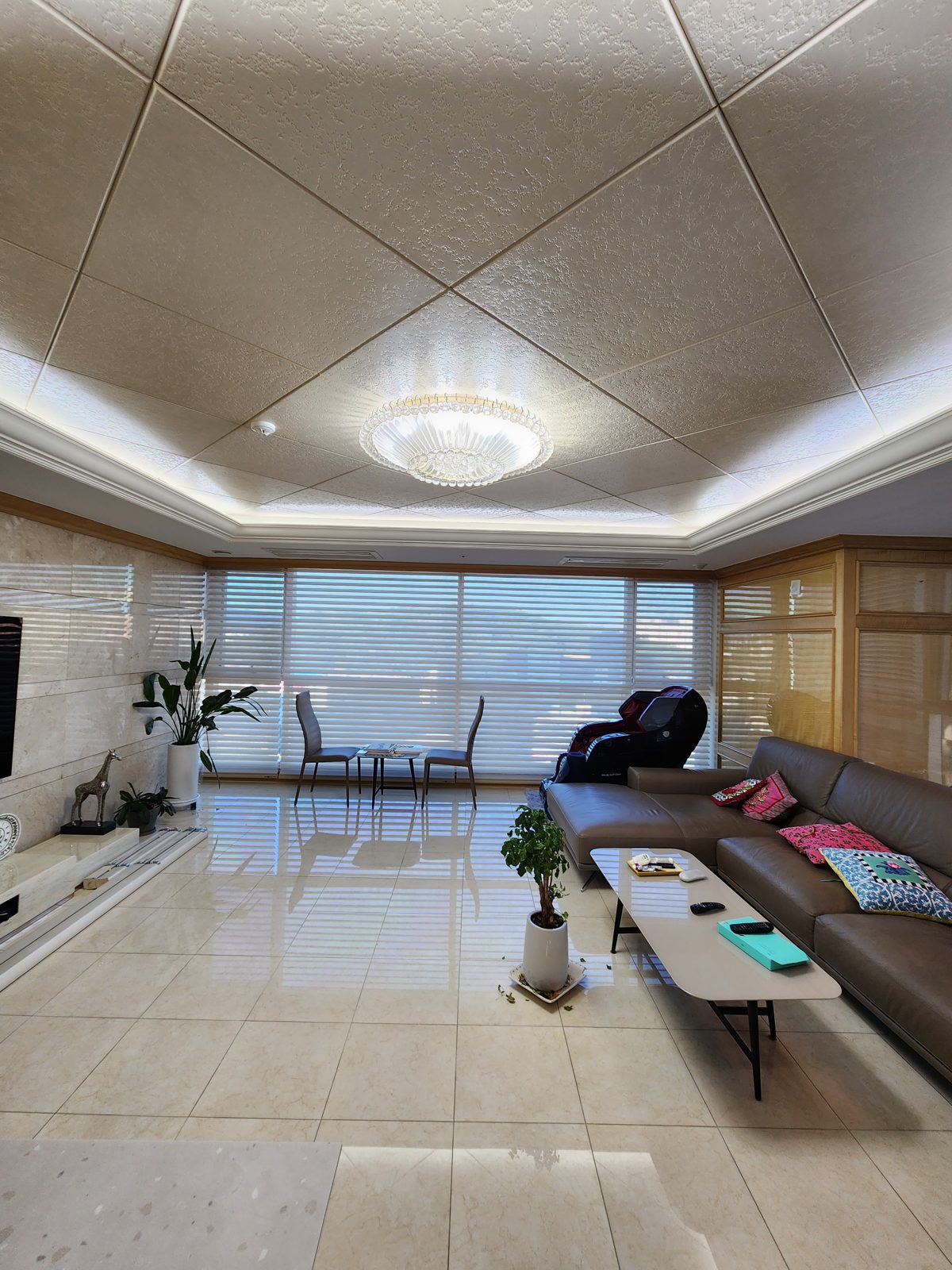 Triple shades in a living room with city view
