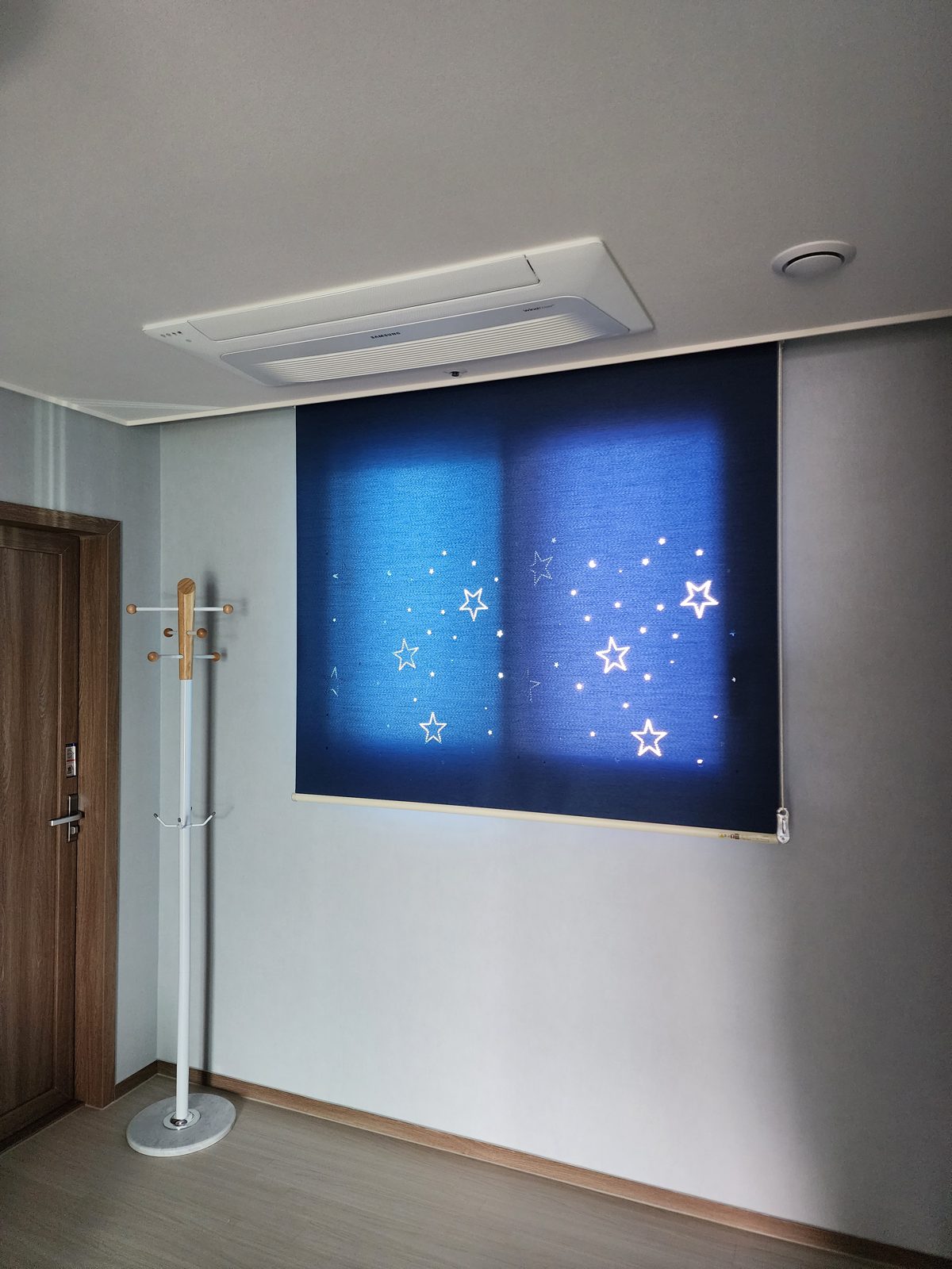 Blue roller shade with star pattern