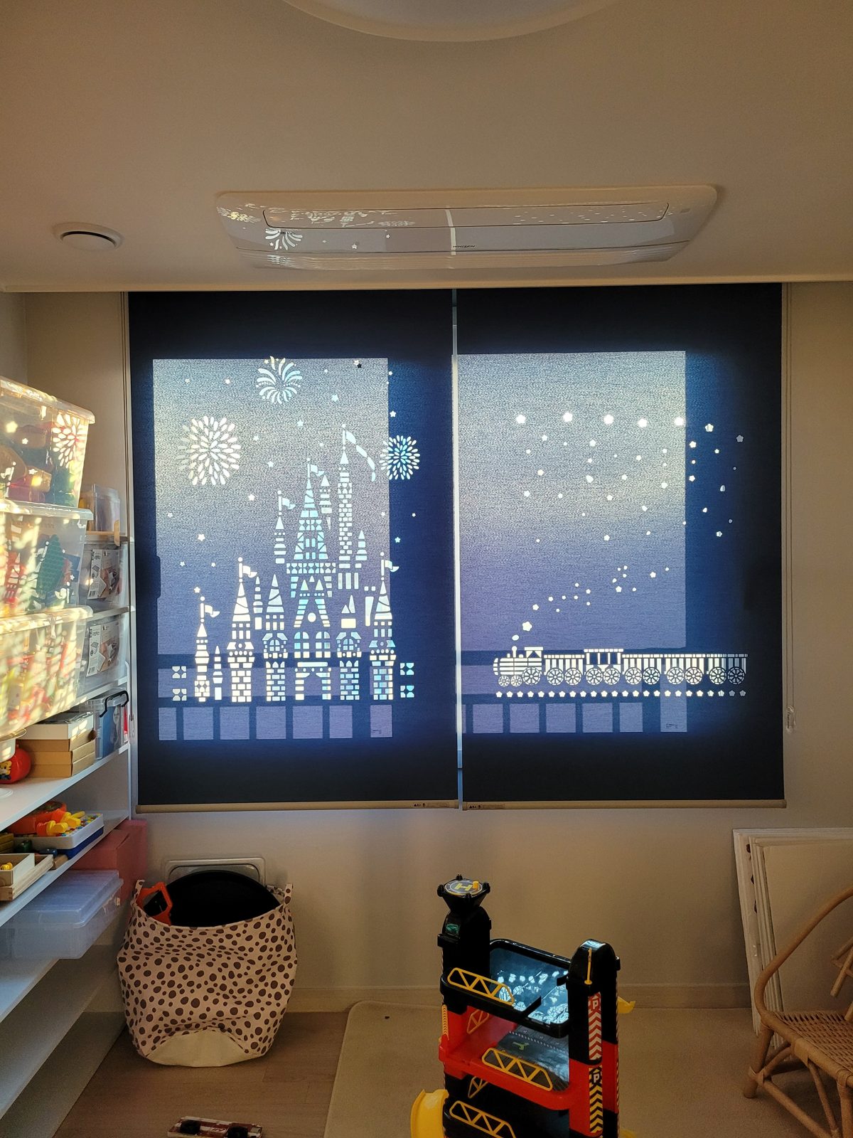 Roller shades with castle pattern in a kids room